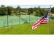 Community tennis courts with American flag and benches for players at 1270 Falling Star Ln, Orlando, FL 32828