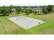 Sand volleyball court surrounded by green grass and community homes at 1270 Falling Star Ln, Orlando, FL 32828