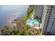 Aerial shot features the lakefront community's pool, pier, and surrounding trees at 13415 Blue Heron Beach Dr # 610, Orlando, FL 32821