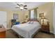 Cozy bedroom featuring a comfortable bed, ceiling fan, charming decor, and soft lighting for relaxing evenings at 13415 Blue Heron Beach Dr # 610, Orlando, FL 32821