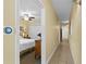 Bright hallway view featuring a bedroom with a ceiling fan and a smart thermostat, leading to additional living spaces at 13415 Blue Heron Beach Dr # 610, Orlando, FL 32821