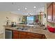 Stylish kitchen with granite countertops, stainless steel appliances, breakfast bar seating, and an open view to the living area at 13415 Blue Heron Beach Dr # 610, Orlando, FL 32821