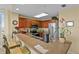 Modern kitchen featuring wooden cabinets, stainless steel appliances, granite countertops, and a breakfast bar with seating at 13415 Blue Heron Beach Dr # 610, Orlando, FL 32821