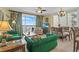 Bright living room with comfortable seating, decorative accents, chandelier, and views to the balcony at 13415 Blue Heron Beach Dr # 610, Orlando, FL 32821
