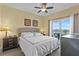 A brightly lit primary bedroom with a king size bed and balcony access at 13415 Blue Heron Beach Dr # 610, Orlando, FL 32821