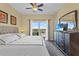 Bedroom with a television and a door to the balcony at 13415 Blue Heron Beach Dr # 610, Orlando, FL 32821