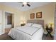 Well-lit primary bedroom featuring neutral decor, large bed, and ensuite bathroom access at 13415 Blue Heron Beach Dr # 610, Orlando, FL 32821