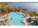 Stunning aerial view of the community pool, surrounded by lush landscaping and picturesque lake views at 13415 Blue Heron Beach Dr # 610, Orlando, FL 32821
