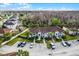 A scenic aerial view of townhomes featuring a red tiled roof and perfectly manicured landscaping in a well-maintained neighborhood at 13801 Timberland Dr # 202, Orlando, FL 32824