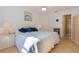 Bedroom with bright natural light, side table, double closet, and attached bath at 13801 Timberland Dr # 202, Orlando, FL 32824