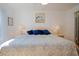 Bright bedroom features a queen bed with a blue patterned comforter and neutral walls at 13801 Timberland Dr # 202, Orlando, FL 32824