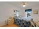 Cozy bedroom with a large bed, wood floors, and bright windows with street view at 13801 Timberland Dr # 202, Orlando, FL 32824