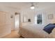 Bright bedroom features a queen bed with a blue patterned comforter, natural light, and wood floors at 13801 Timberland Dr # 202, Orlando, FL 32824