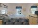 Bedroom featuring bright natural light, an ample dresser, and a large bed at 13801 Timberland Dr # 202, Orlando, FL 32824
