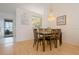 Bright dining room featuring a chandelier, wood floors, and seating for six at 13801 Timberland Dr # 202, Orlando, FL 32824