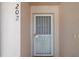 A close-up of a front door featuring a secure screen and a decorative design at 13801 Timberland Dr # 202, Orlando, FL 32824