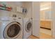 Convenient laundry room with a washer, dryer, shelving, and access to the bathroom at 13801 Timberland Dr # 202, Orlando, FL 32824