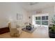 Bright living room with a ceiling fan and a glass door leading to a balcony at 13801 Timberland Dr # 202, Orlando, FL 32824