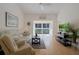 Inviting living room featuring light wood floors, a ceiling fan, and a balcony view at 13801 Timberland Dr # 202, Orlando, FL 32824