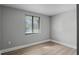 A bright bedroom features a large window, neutral walls, and modern flooring at 144 Delespine Dr, Debary, FL 32713
