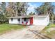 Charming single-story home with a bright red door and a well-maintained lawn at 144 Delespine Dr, Debary, FL 32713