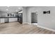 Open-concept kitchen and living area with stainless steel appliances and modern flooring at 144 Delespine Dr, Debary, FL 32713