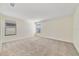 Large bedroom with plush carpeting and ample natural light from two windows at 15088 Night Heron Dr, Winter Garden, FL 34787