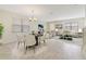 Bright and open dining area features elegant lighting and seamless flow to living area, perfect for entertaining at 15088 Night Heron Dr, Winter Garden, FL 34787