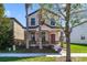 Charming two-story home with stone accents on the front porch pillars and a manicured front lawn at 15088 Night Heron Dr, Winter Garden, FL 34787