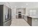 Contemporary kitchen featuring stainless steel appliances, gray cabinets, and a breakfast bar at 15088 Night Heron Dr, Winter Garden, FL 34787