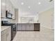 Modern kitchen featuring stainless steel appliances, sleek cabinets and a view to the living area at 15088 Night Heron Dr, Winter Garden, FL 34787