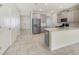 Open kitchen showcasing stainless steel appliances, bright white countertops and a view to the living area at 15088 Night Heron Dr, Winter Garden, FL 34787