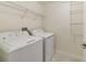 Functional laundry room with modern washer and dryer plus wire shelving for ample storage at 15088 Night Heron Dr, Winter Garden, FL 34787