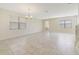Spacious living room featuring tile floors, neutral walls, and a modern chandelier at 15088 Night Heron Dr, Winter Garden, FL 34787