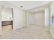 Spacious open living area with tile flooring, with view of the kitchen beyond the pillar at 15088 Night Heron Dr, Winter Garden, FL 34787