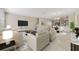 Bright living room features tile flooring, neutral walls, and an open concept design leading into dining area at 15088 Night Heron Dr, Winter Garden, FL 34787