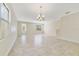 Spacious living room with tile flooring, natural light, and elegant chandelier at 15088 Night Heron Dr, Winter Garden, FL 34787