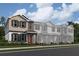 Charming townhome with neutral siding, dark shutters and stone accents on a landscaped lot at 15364 Burgtheater Dr, Winter Garden, FL 34787