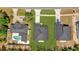 Breathtaking aerial view of three adjacent homes boasting well-manicured lawns and inviting private pools at 166 Marion Oaks Ln, Ocala, FL 34473