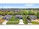 Aerial view of a single-Gathering home with manicured lawn in a suburban neighborhood at 166 Marion Oaks Ln, Ocala, FL 34473