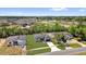 Aerial view of a well-maintained neighborhood with lush greenery and clear blue skies at 166 Marion Oaks Ln, Ocala, FL 34473