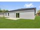 Expansive backyard featuring a well-maintained lawn and sliding glass door at 166 Marion Oaks Ln, Ocala, FL 34473