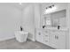 Spacious bathroom featuring a freestanding tub and double vanity with quartz countertop at 166 Marion Oaks Ln, Ocala, FL 34473