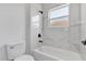 Modern bathroom featuring a sleek white bathtub with marble-style tile and black fixtures at 166 Marion Oaks Ln, Ocala, FL 34473