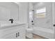 Well-lit bathroom with tub, shower, marble-style tile, and a sleek white vanity at 166 Marion Oaks Ln, Ocala, FL 34473