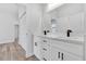 Bright bathroom featuring double vanity with quartz countertop and sleek black hardware at 166 Marion Oaks Ln, Ocala, FL 34473