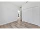 Bedroom with wood-look floors, closet, and a doorway into the kitchen at 166 Marion Oaks Ln, Ocala, FL 34473