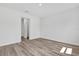 Empty bedroom with wood-look floors, and access to the closet at 166 Marion Oaks Ln, Ocala, FL 34473