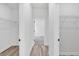Hallway with a closet on each side and tile floors at the end at 166 Marion Oaks Ln, Ocala, FL 34473