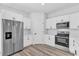 Modern kitchen features stainless steel appliances, white cabinets, and hard surface floors at 166 Marion Oaks Ln, Ocala, FL 34473